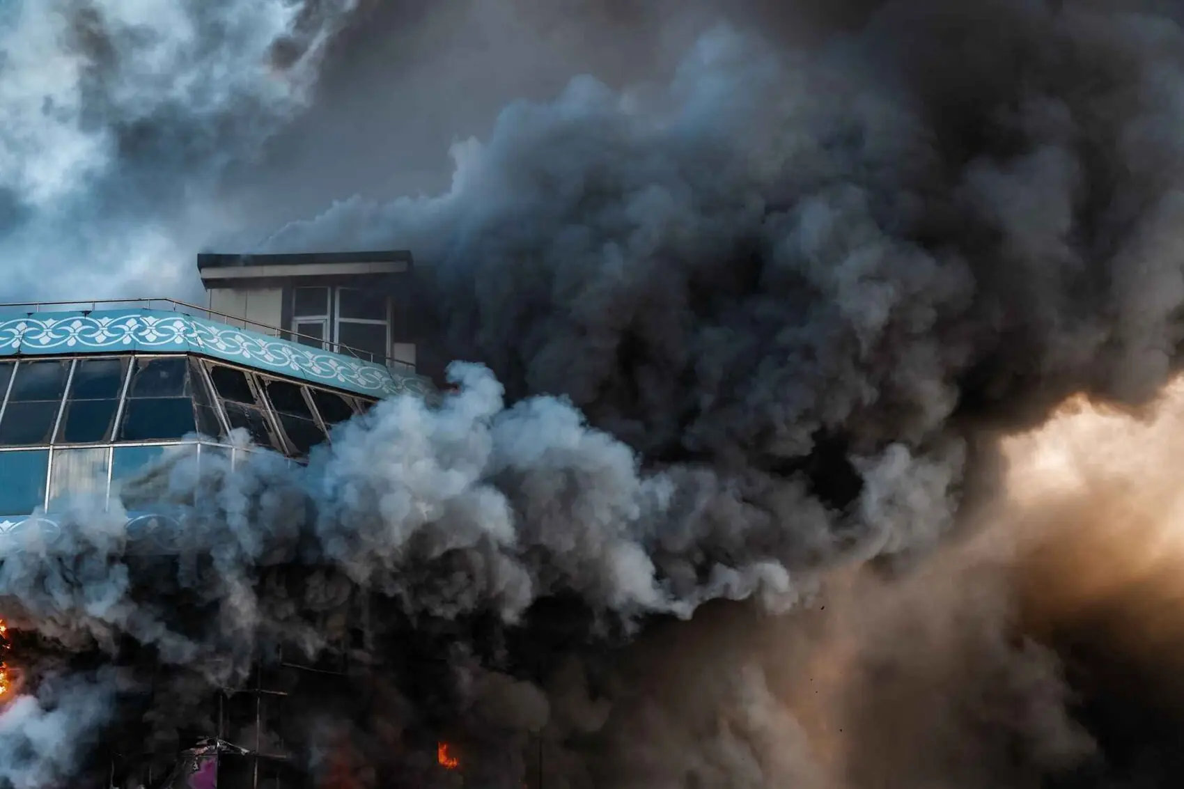 smoke coming out of a building that is on fire