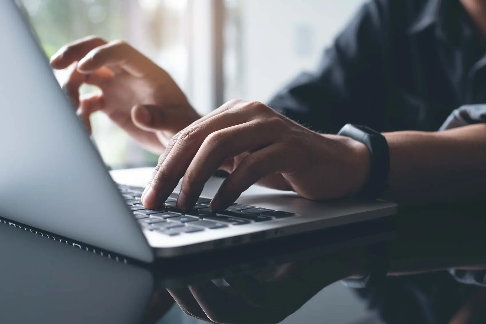 employee or business owner at cyber company typing on computer