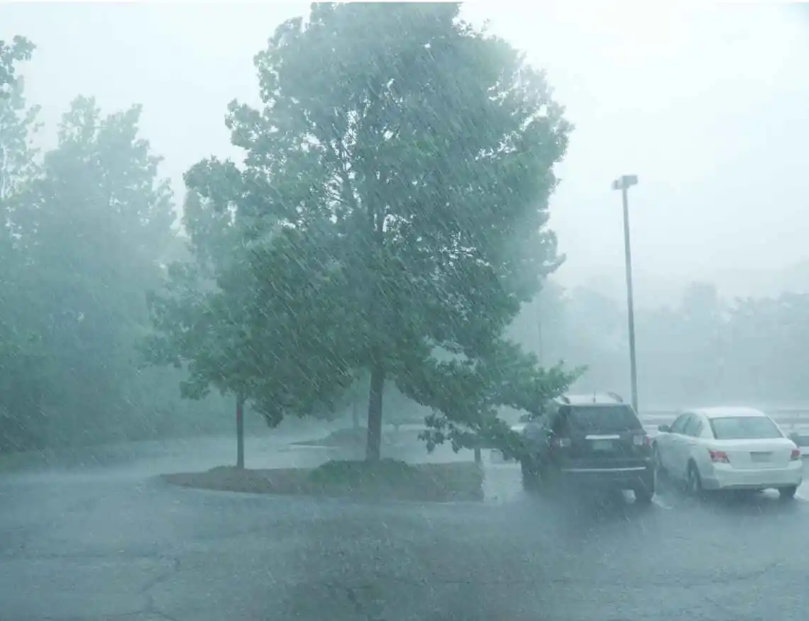 very heavy rainstorm in parking lot that can cause flooding