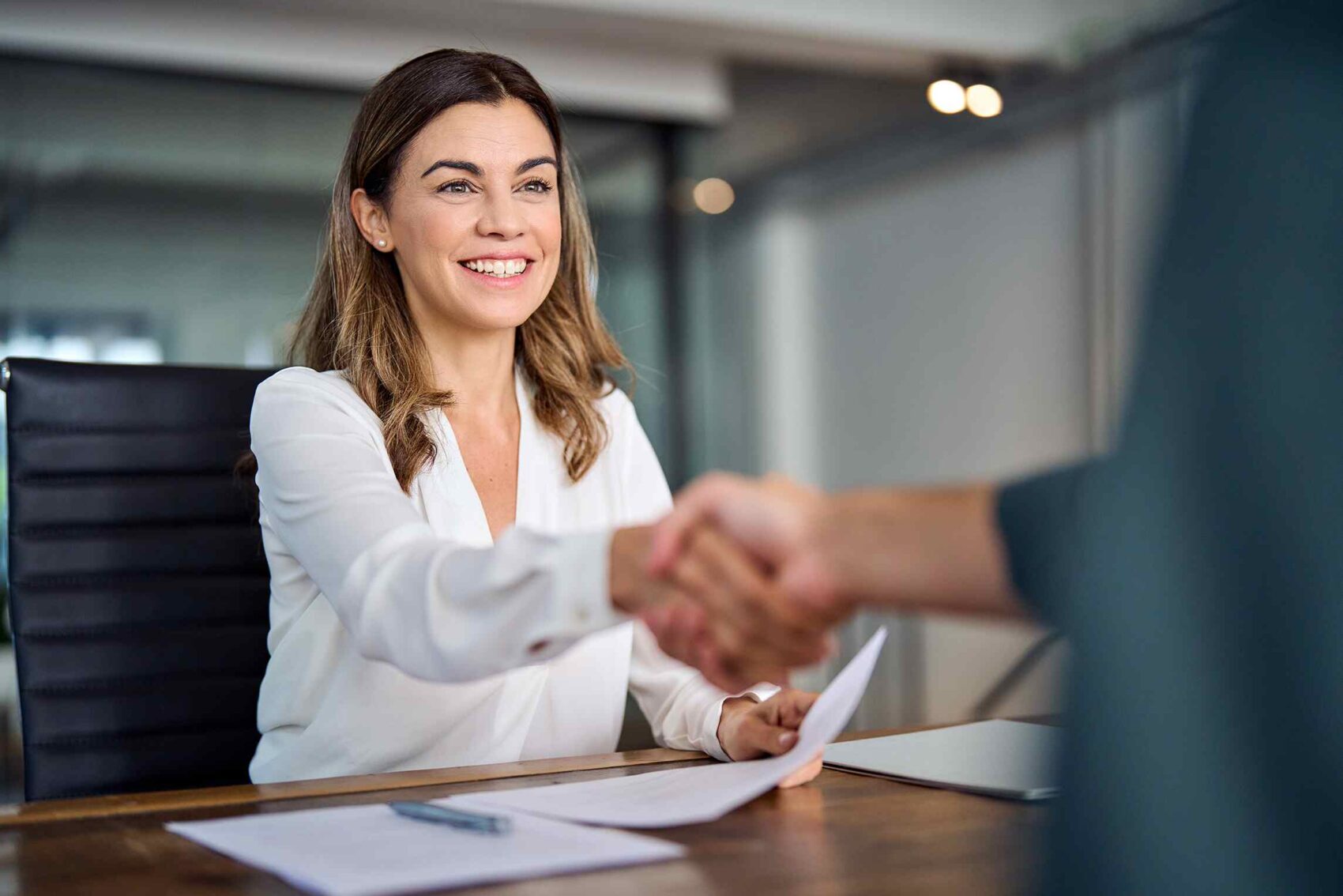 woman-shaking-hand-insurance-office