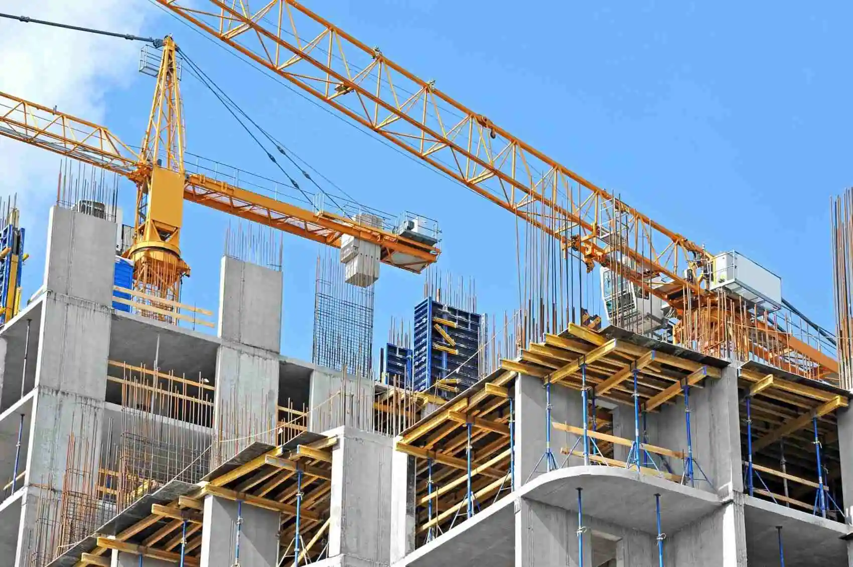 active construction site with cranes holding building equipment