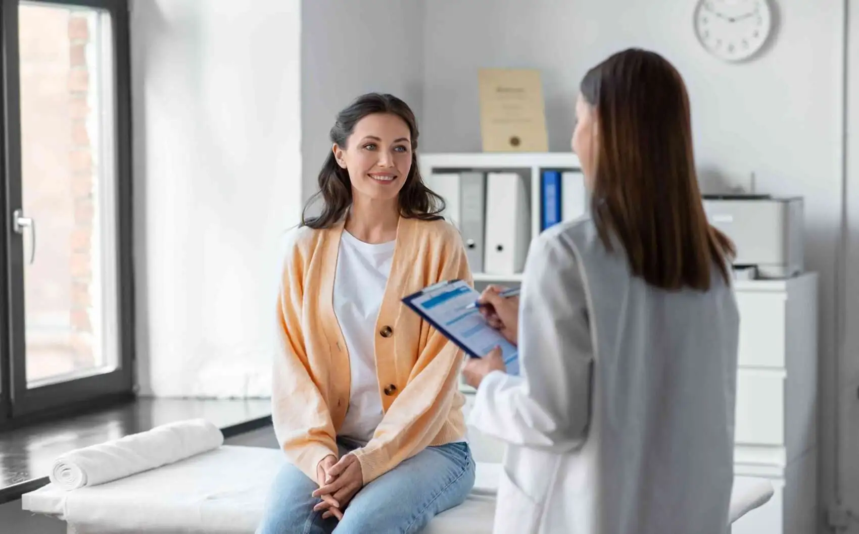 patient in doctor's office going over health insurance benefits