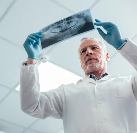 doctor looking at an xray of a patients mouth