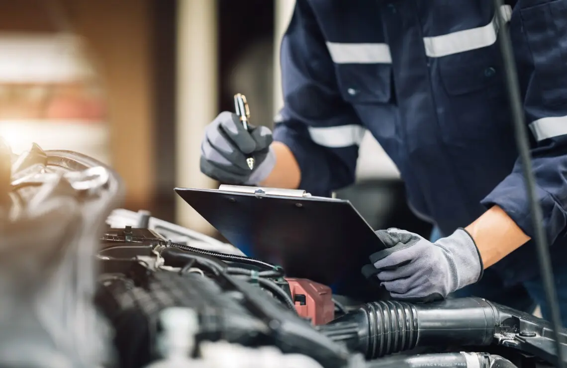 Mechanic performing maintenance on a car engine