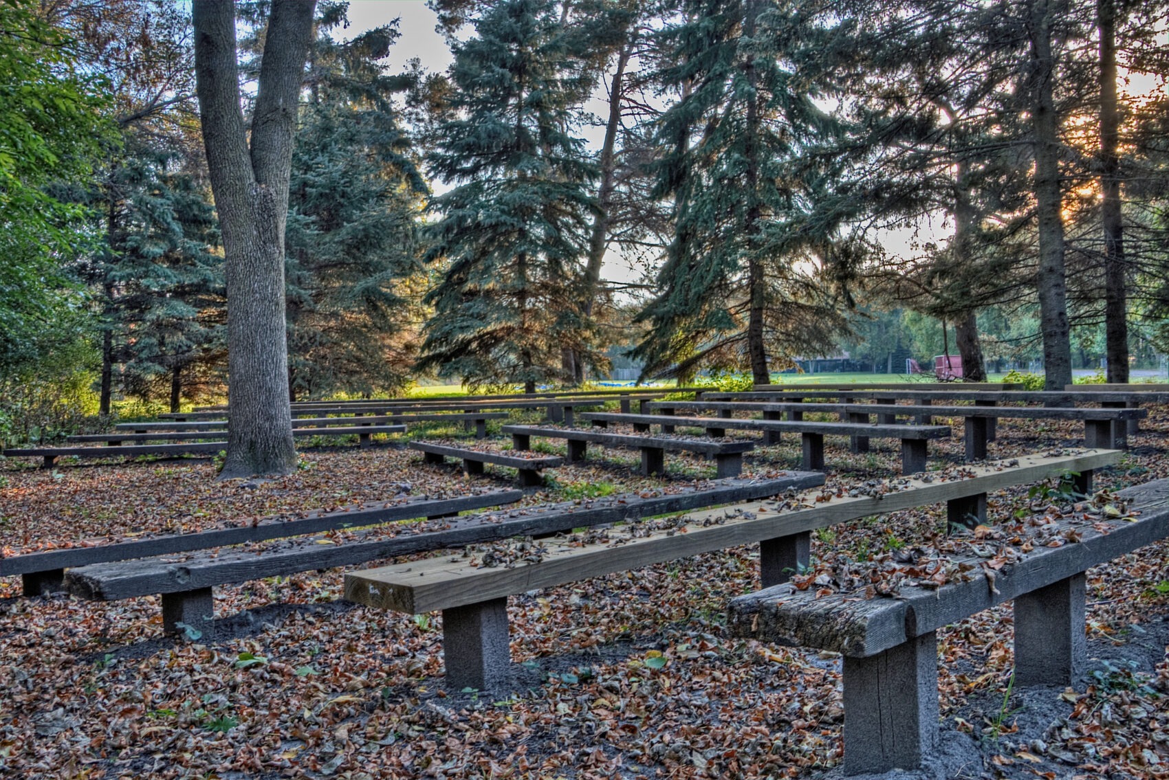 Empty outdoor seating area at a summer camp during off-season, representing halted camp operations
