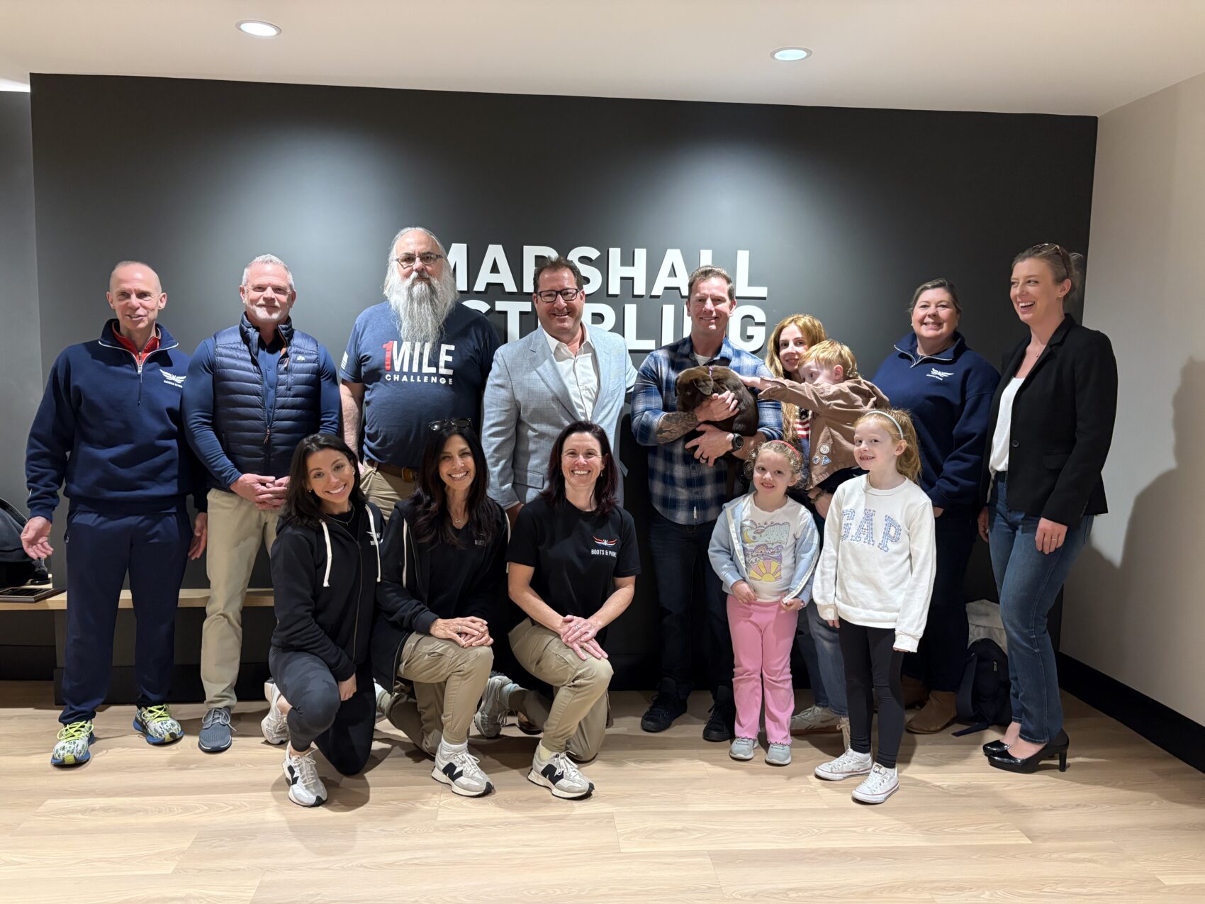 A veteran and FDNY first responder receives companion dog from Marshall and Sterling CEO Eric Diamond through Boots and Paws program in Poughkeepsie