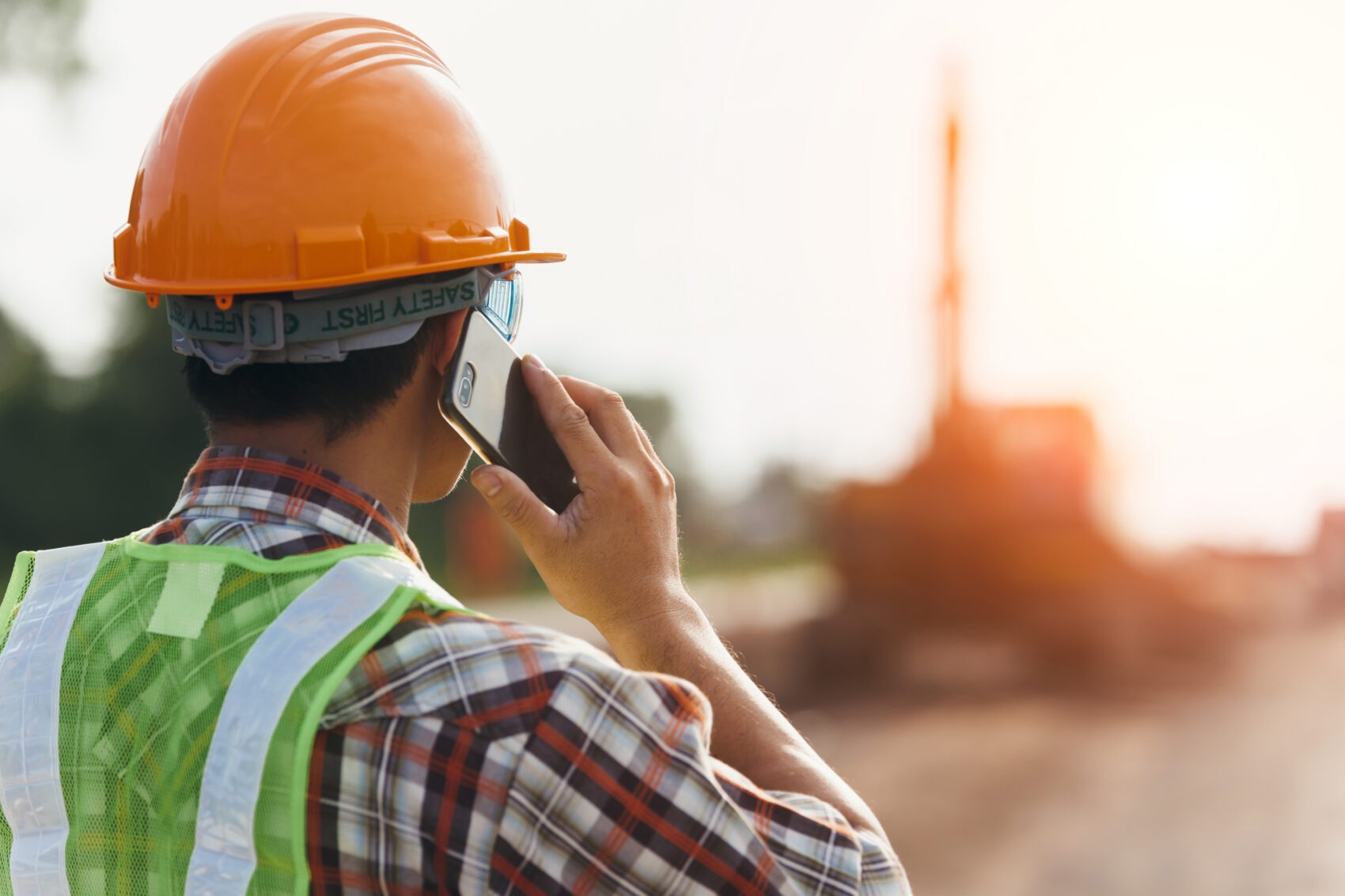 Construction contractor speaking with claims advocate over phone reviewing an active workers’ compensation claim