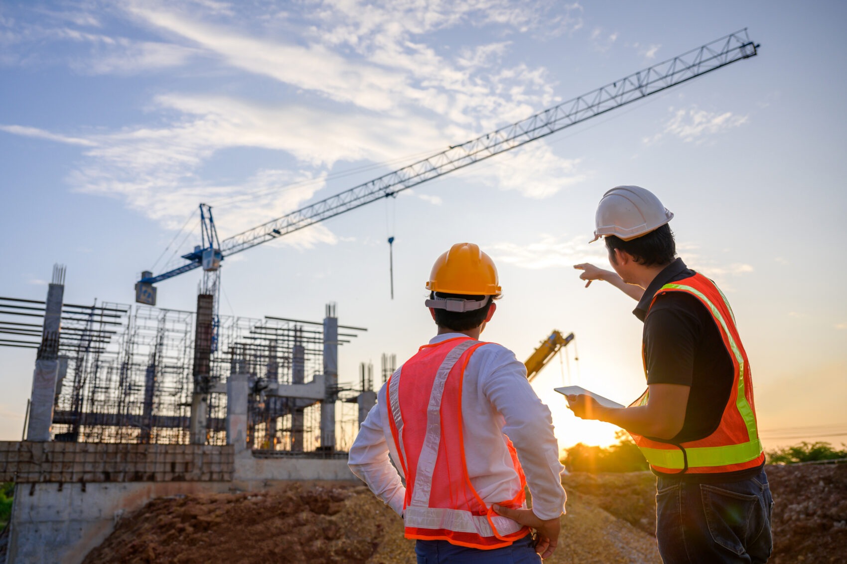 General contractor reviewing subcontractor insurance certificates and contract documents on a jobsite