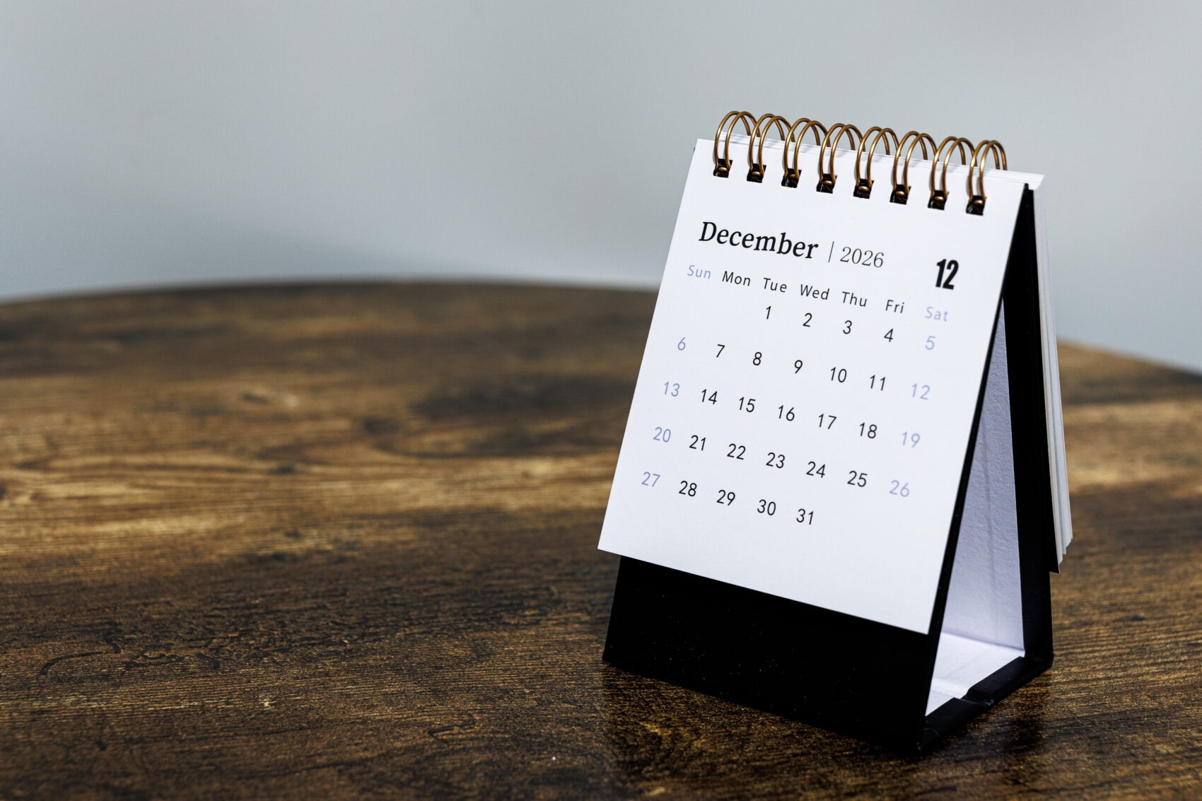 A desk calendar open to December representing SECURE 2.0 plan amendment deadline 2026