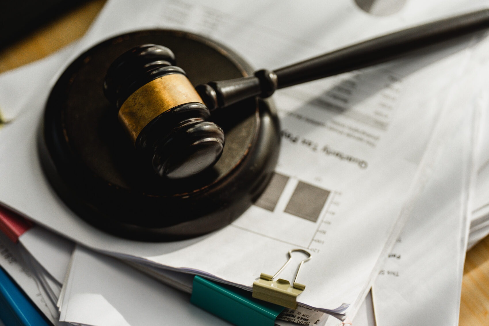 Wooden gavel rests on documents representing 401(k) settlement