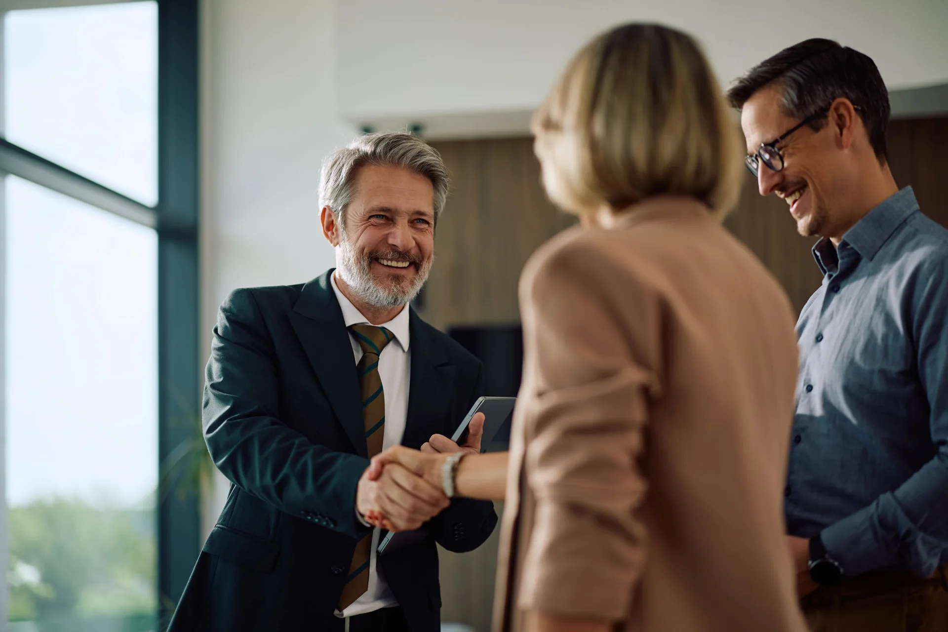 Business meeting participants greeting each other with a handshake